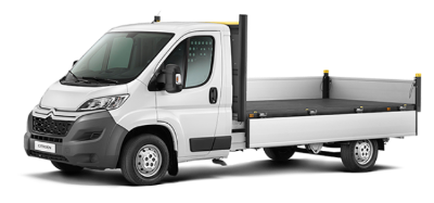 White flatbed lorry viewed from the side.