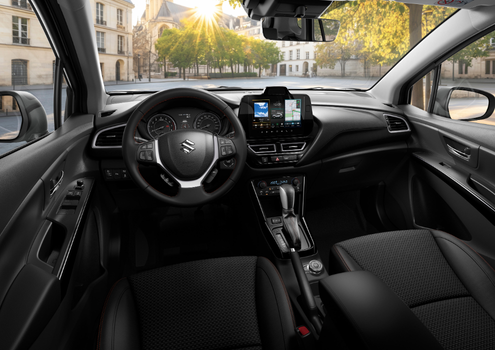 Interior view of a car dashboard and steering wheel with digital displays.